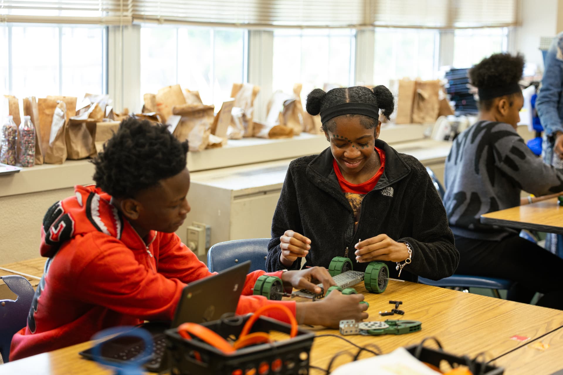 Two PHMS students assembling a classroom robotics project